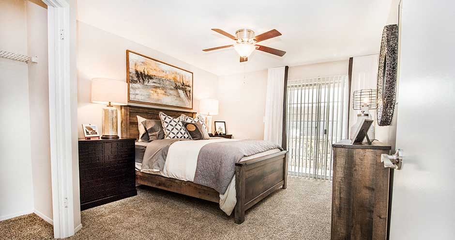 a bedroom with a bed and a ceiling fan