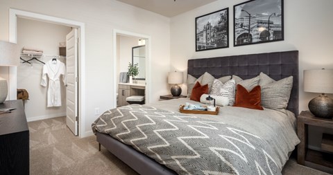 A bedroom with a large bed and a mirror on the wall.