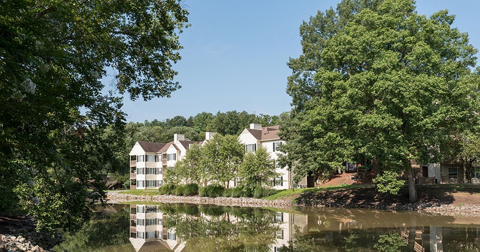 a view of a lake with apartment buildings in the background