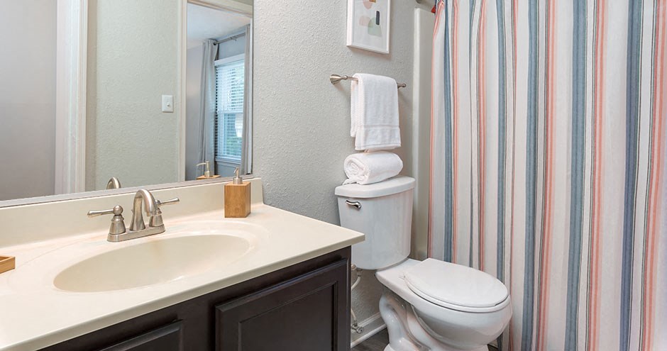 a bathroom with a sink toilet and a shower