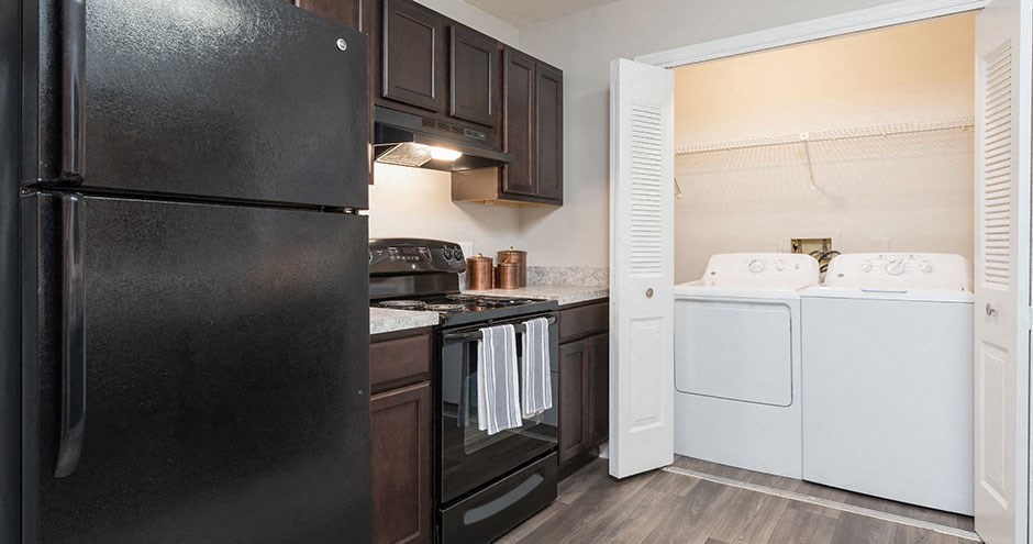 a kitchen with black appliances and a white stove and refrigerator