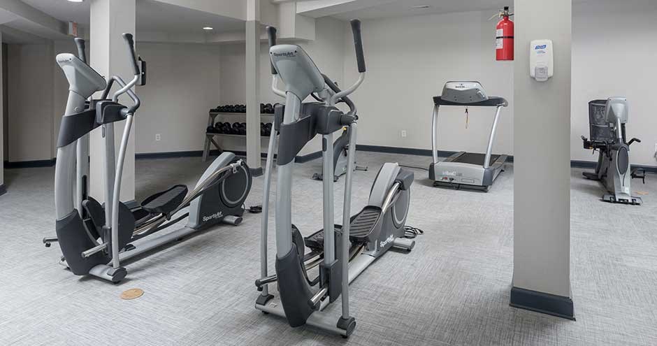 a group of exercise equipment in a gym room