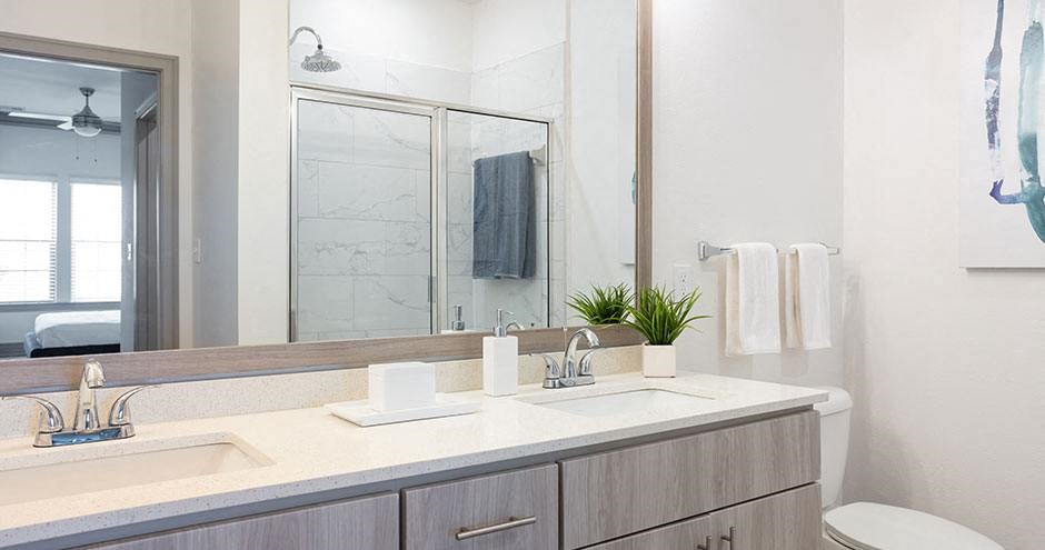 a bathroom with two sinks and a large mirror