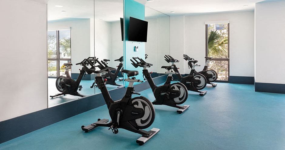 a group of exercise bikes in a room