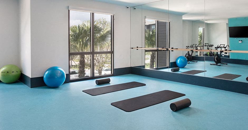 a yoga room with yoga mats and exercise balls
