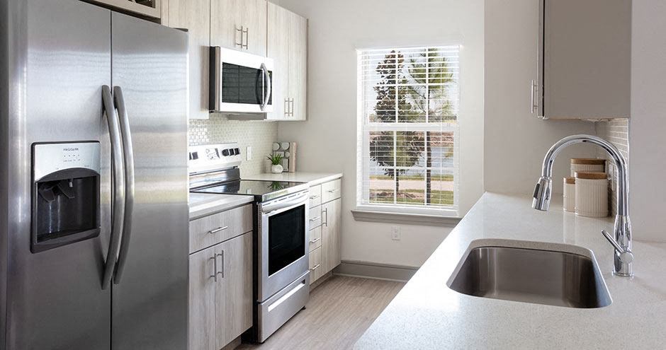 a kitchen with stainless steel appliances and a window
