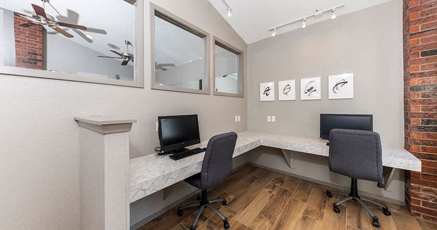 a home office with two chairs and a desk with a computer