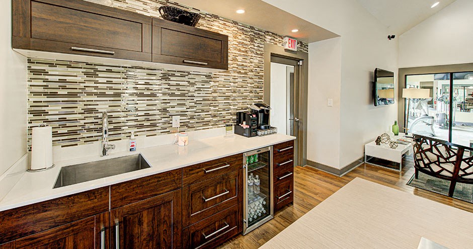 a kitchen with a sink and a coffee machine