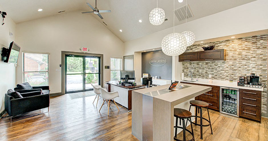 a kitchen with a bar and a living room