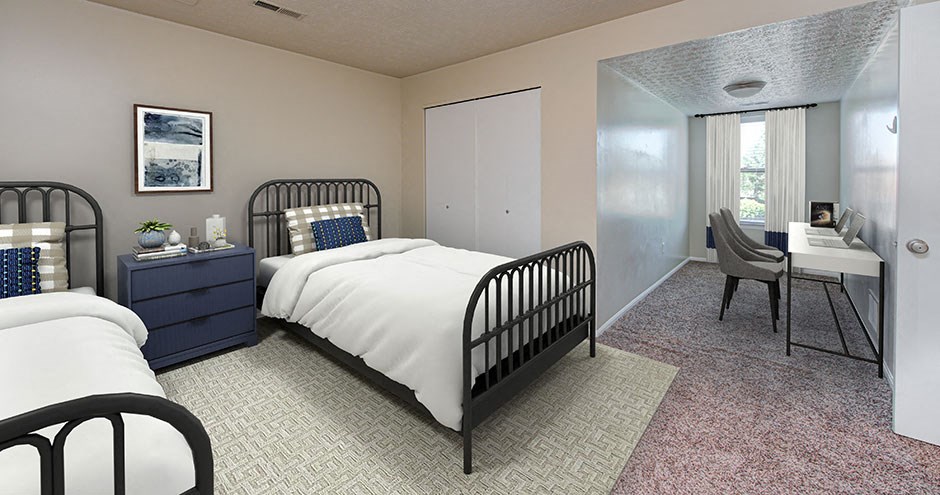 a bedroom with a bed and a desk