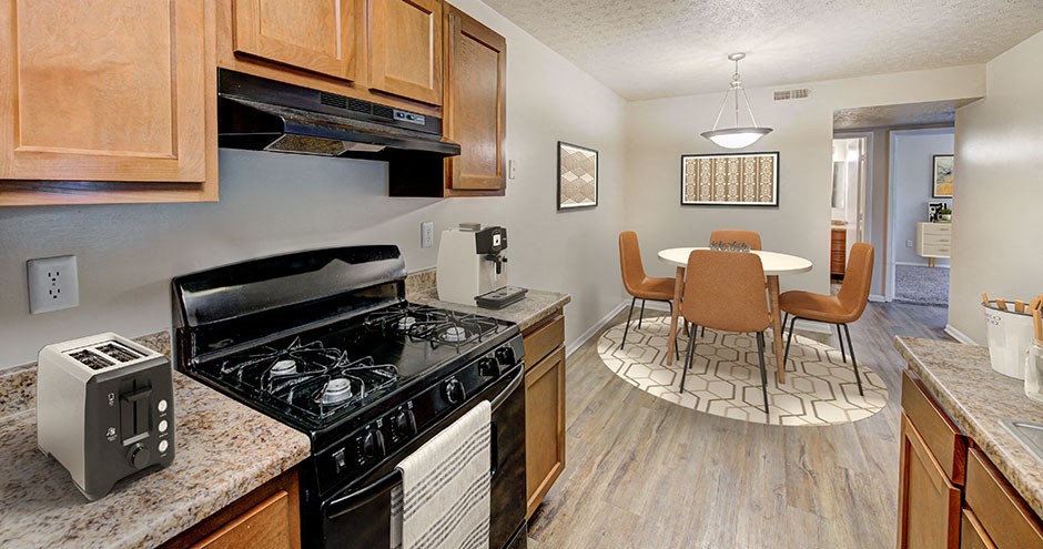 our apartments have a kitchen and dining room with a table and chairs