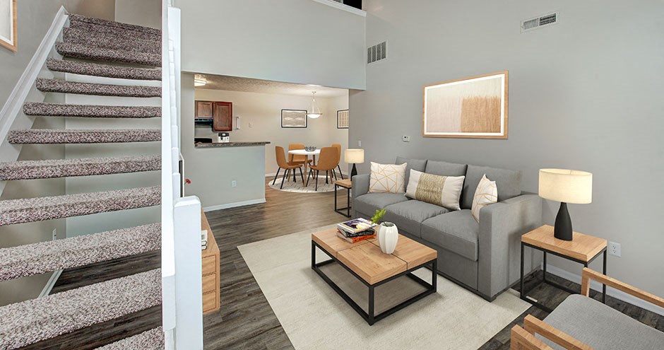 a living room with a couch and a staircase
