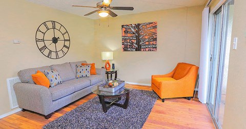 a living room with a couch and a clock on the wall