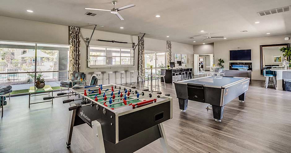 a game room with two pool tables