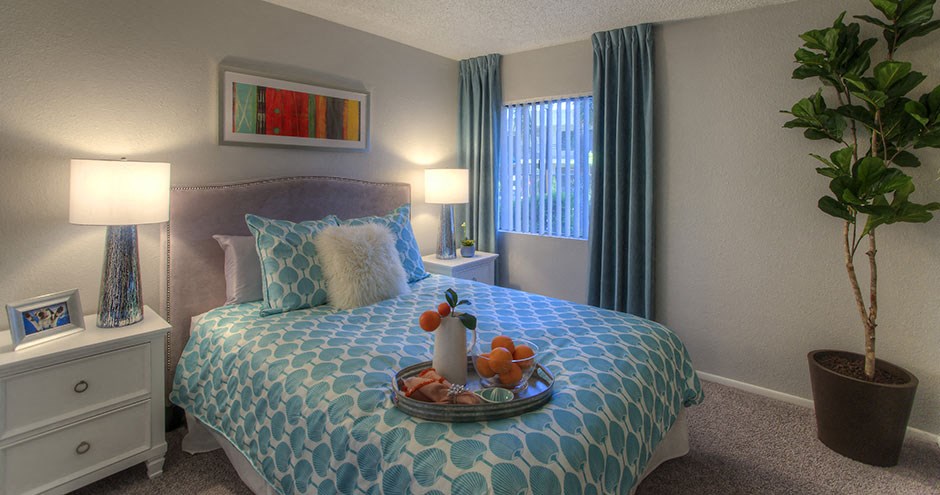 a bedroom with a bed and a plate of fruit on it