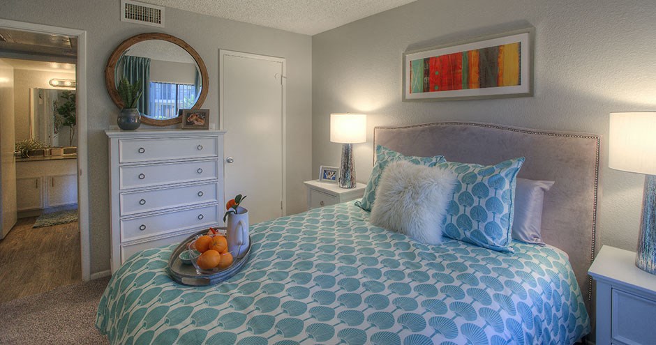 a bedroom with a bed and a tray of fruit