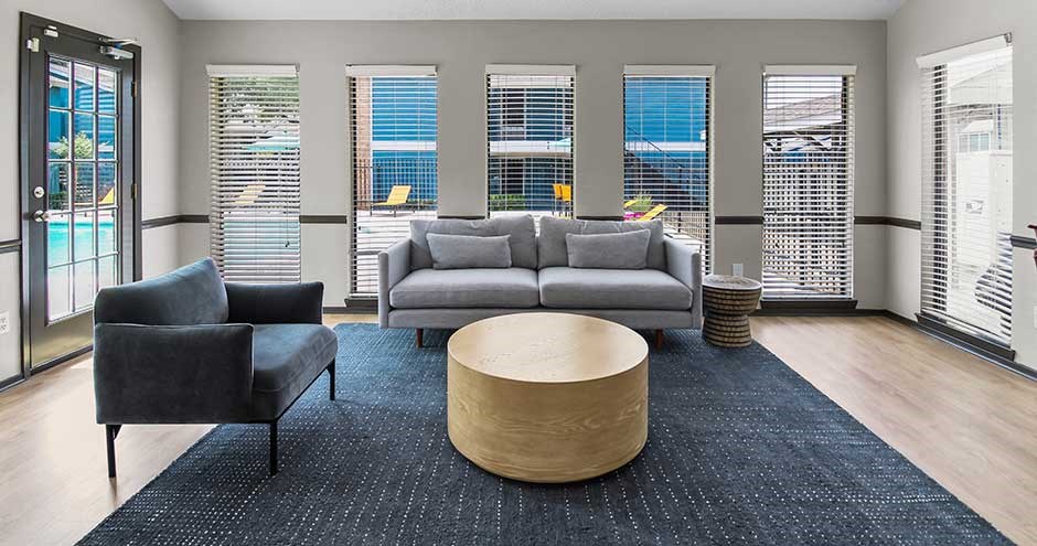 a living room filled with furniture and a large window