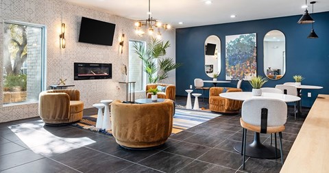 A modern living room with a fireplace and a television mounted on the wall.