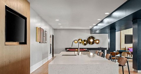 a kitchen with a sink and a table with chairs