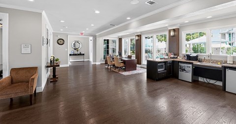 A living room with a brown sofa and a wooden floor.