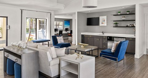 A modern living room with a white sofa and a blue chair.