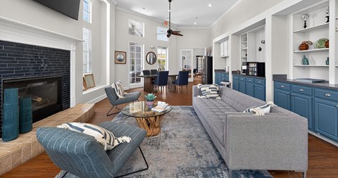 A living room with a grey couch and a fireplace.