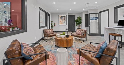 A modern living room with brown leather chairs and a coffee table.