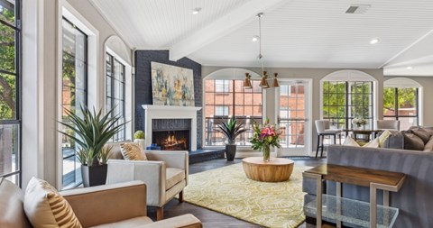A living room with a fireplace and a painting on the wall.