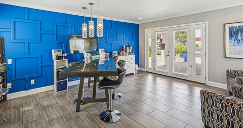 A dining room with a table and chairs.