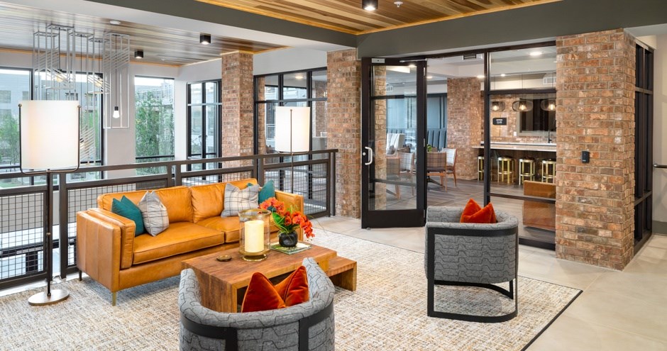 A living room with a couch, a chair, and a coffee table.