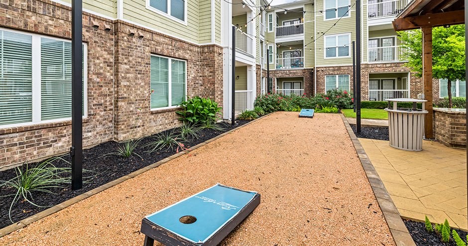 a brick apartment building with a brick walkway with a blue game controller
