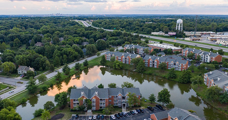 an aerial view of a flooded neighborhood with houses and a pond