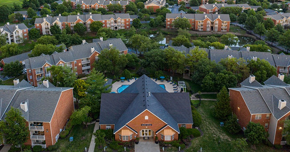 an aerial view of a neighborhood with houses and a swimming pool
