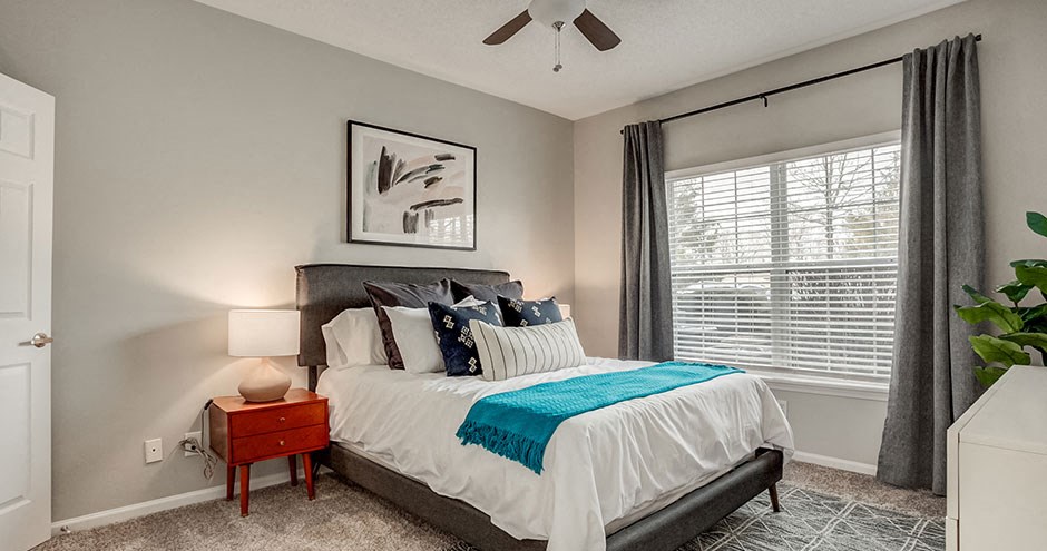 a bedroom with a bed and a ceiling fan