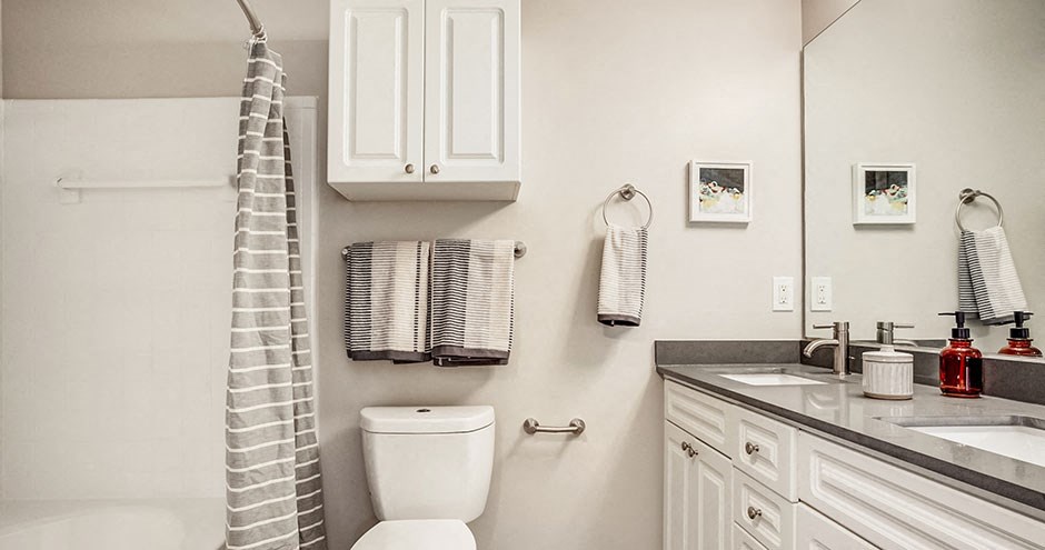 a bathroom with a toilet and a sink and a shower