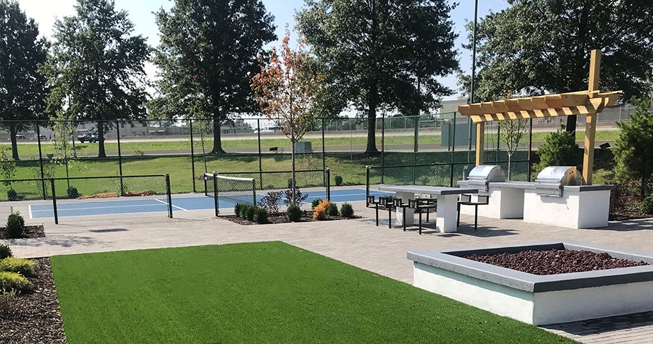 a backyard with a pool and a picnic area and a pergola