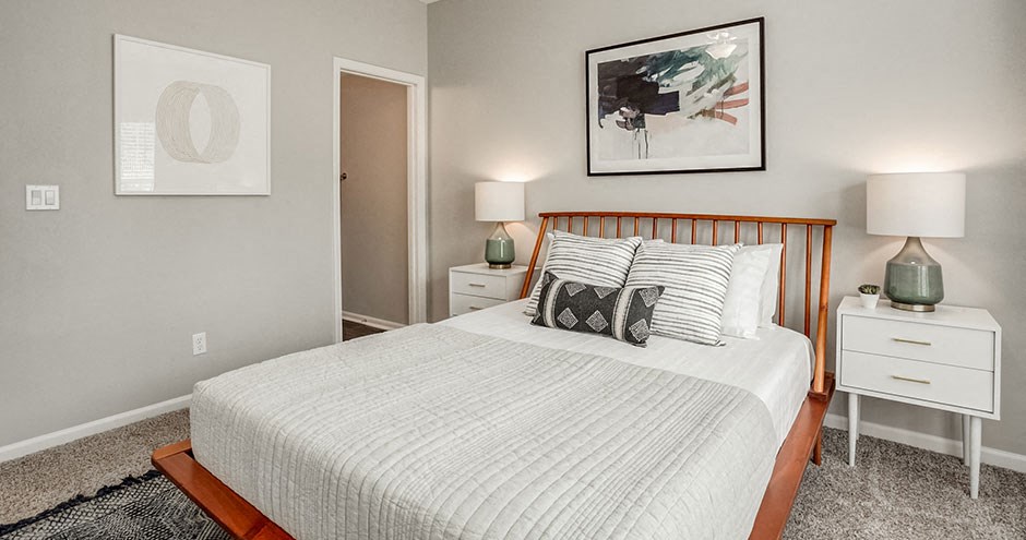 a bedroom with a bed and two lamps