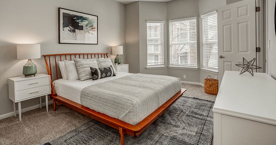 a bedroom with a bed and some windows