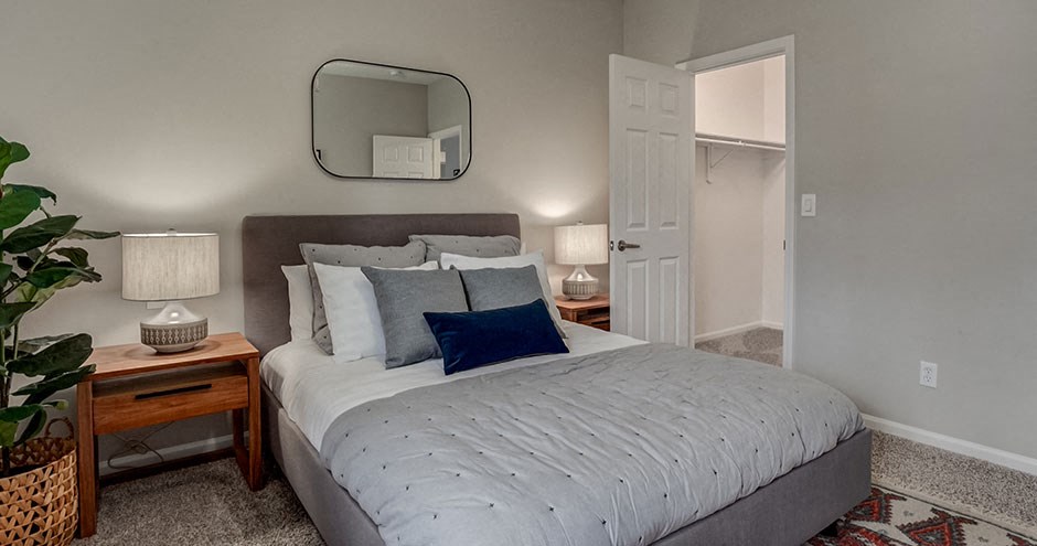 a bedroom with a bed and a mirror