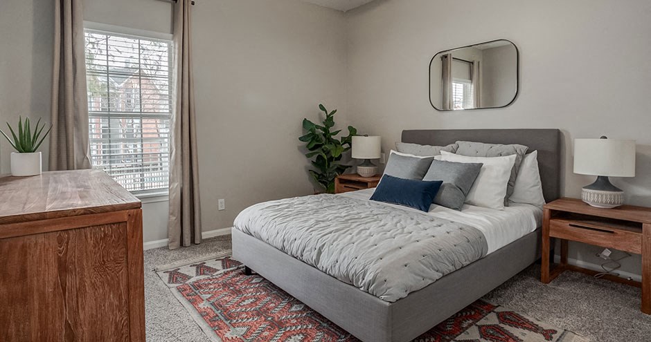 a bedroom with a bed and a window