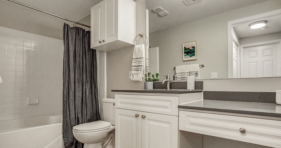 a white bathroom with a toilet and a sink