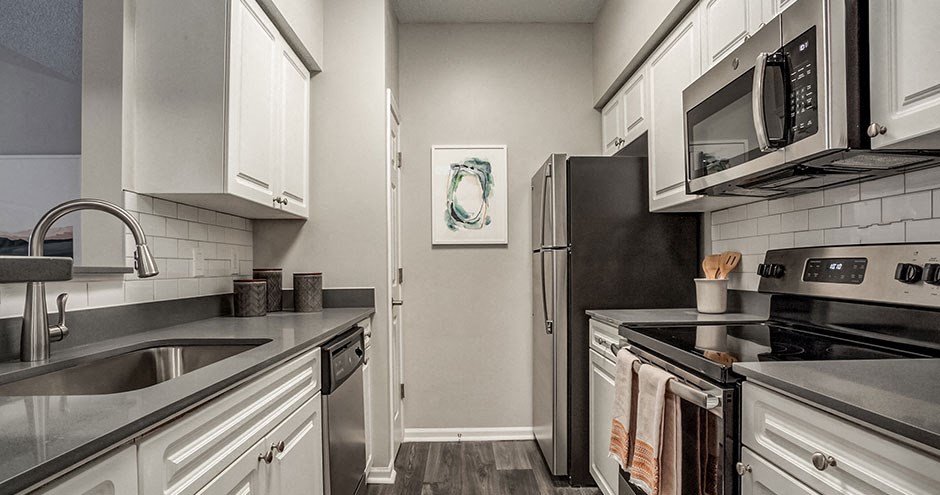 a kitchen with stainless steel appliances and white cabinets