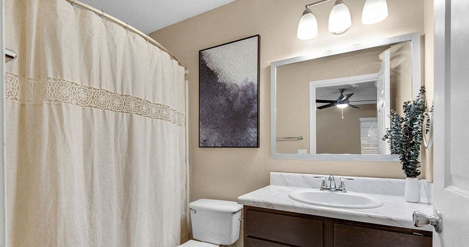 a bathroom with a shower curtain and a sink