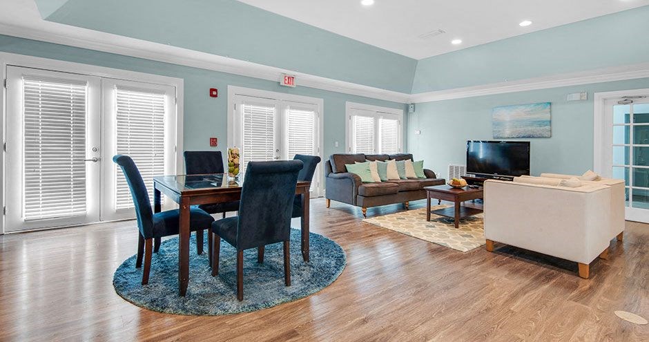 a living room with a table and chairs and a television