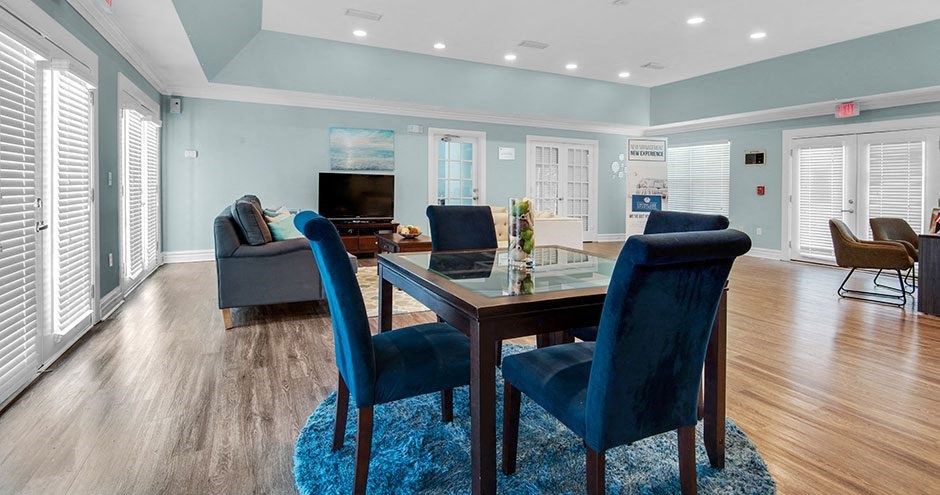 a living room with blue chairs and a table
