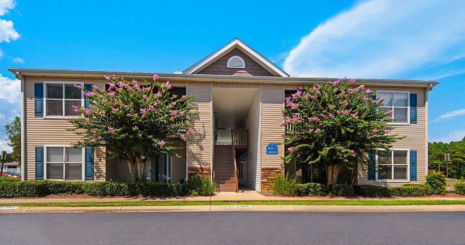 a large house with two trees in front of it