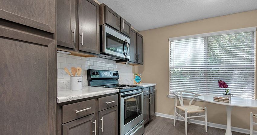a kitchen with stainless steel appliances and a window