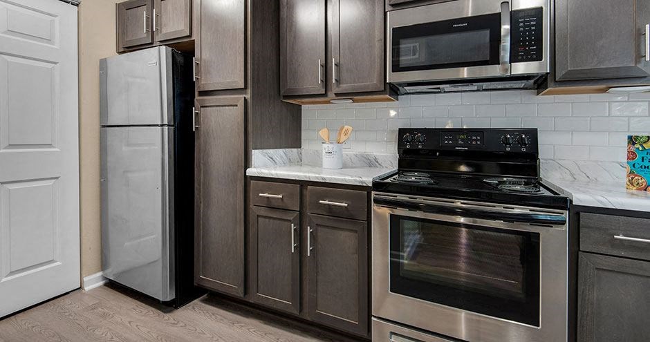 a kitchen with stainless steel appliances and wooden cabinets