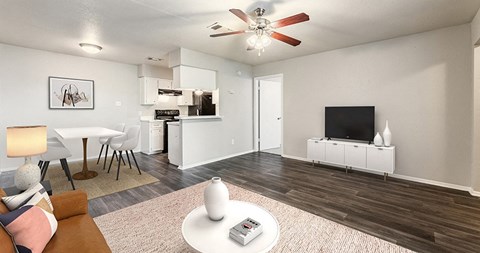 an open living room and kitchen with a tv