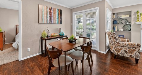 A dining room with a wooden table and chairs.